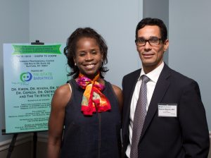 A patient proudly stands with her bariatric surgeon Dr. Rivera